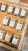 kitchen drawer open with organized bamboo spice rack and glass spice containers