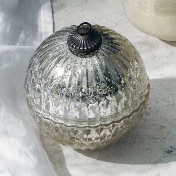 A Mercury Glass Ornament Candle with a silver top and base, featuring a geometric pattern.