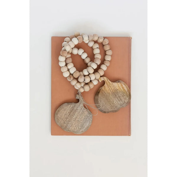 Wooden beads and decorative items on a brown card with a white background