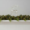 Acrylic Reindeer Figurine on white mantle with garland and christmas lights