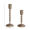 Two antique brass candle holders with dimensions indicated on a white background