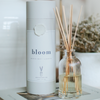 Reed diffuser set with 'bloom' container on a surface