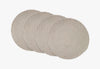 Set of four round woven placemats on a white background