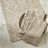 Patterned table runner and napkins on a textured surface with decorative elements.