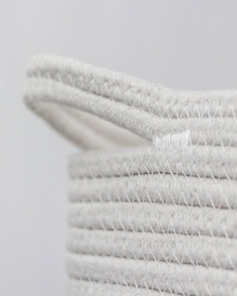 cream and white storage basket handle