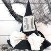 A handmade witch hat decor featuring a black hat with a white bow and a number 31 on the front, designed for Halloween decoration.
