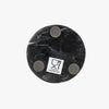 Black marble spoon rest with four gray circular pads on a white background