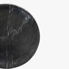 Round black marble spoon rest on a white background