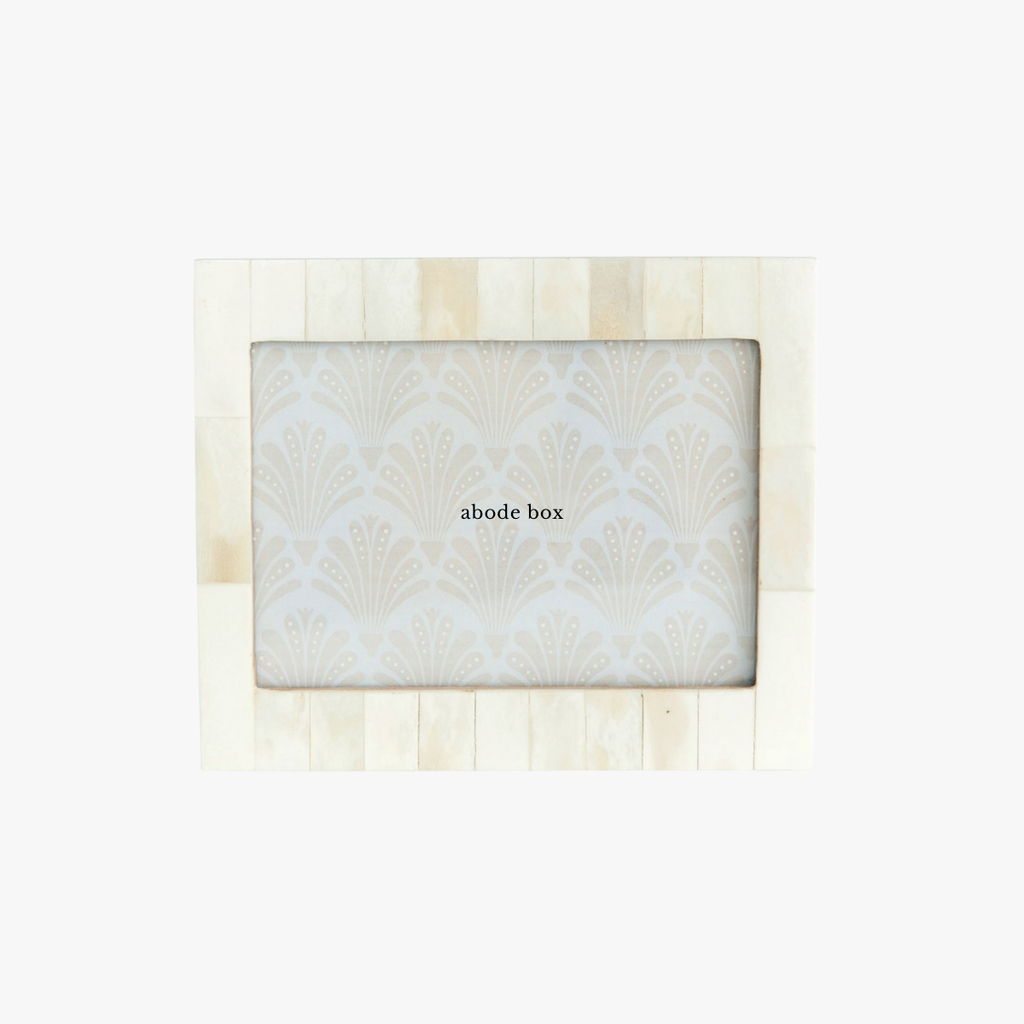 Product packaging with 'abode box' branding on a light wooden background