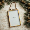 Brass Frame Ornament with modern rustic garland on wooden surface