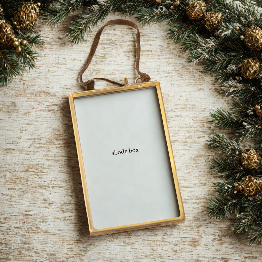 Brass Frame Ornament with modern rustic garland on wooden surface