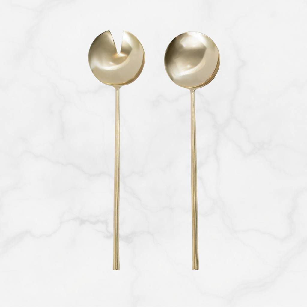Two gold spoons on a white background