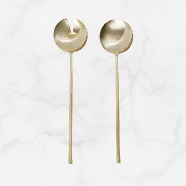 Two gold spoons on a white background
