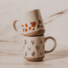 Brown Leaves Stoneware Coffee Mug stacked with another coffee mug