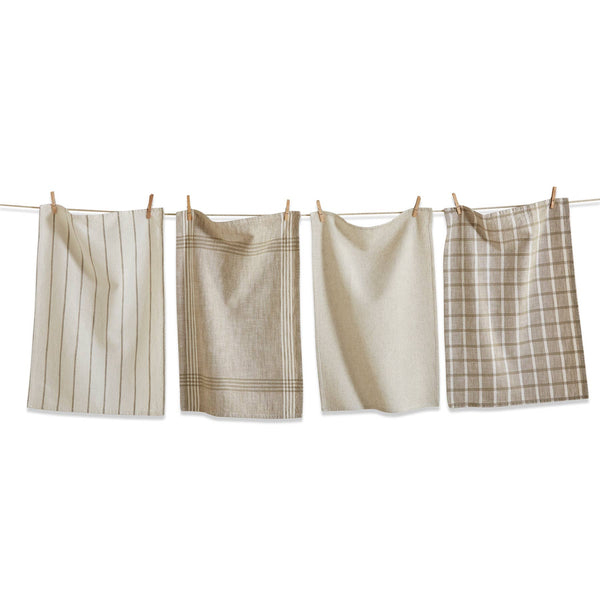 Four beige and cream kitchen towels with different patterns (stripes, check, solid, and plaid) hanging from a white clothesline with wooden clothespins against a solid white background.