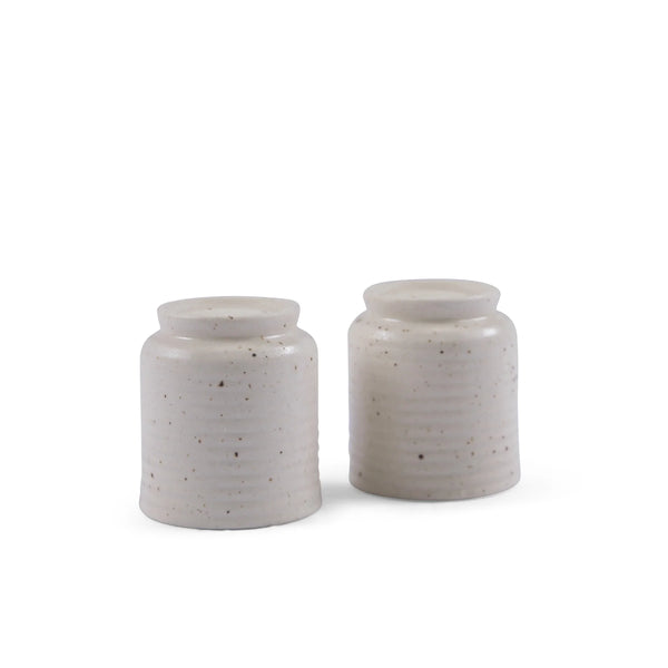ceramic salt & pepper shakers with speckled texture on a white background