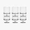 Three clear glass highball glasses on a white background