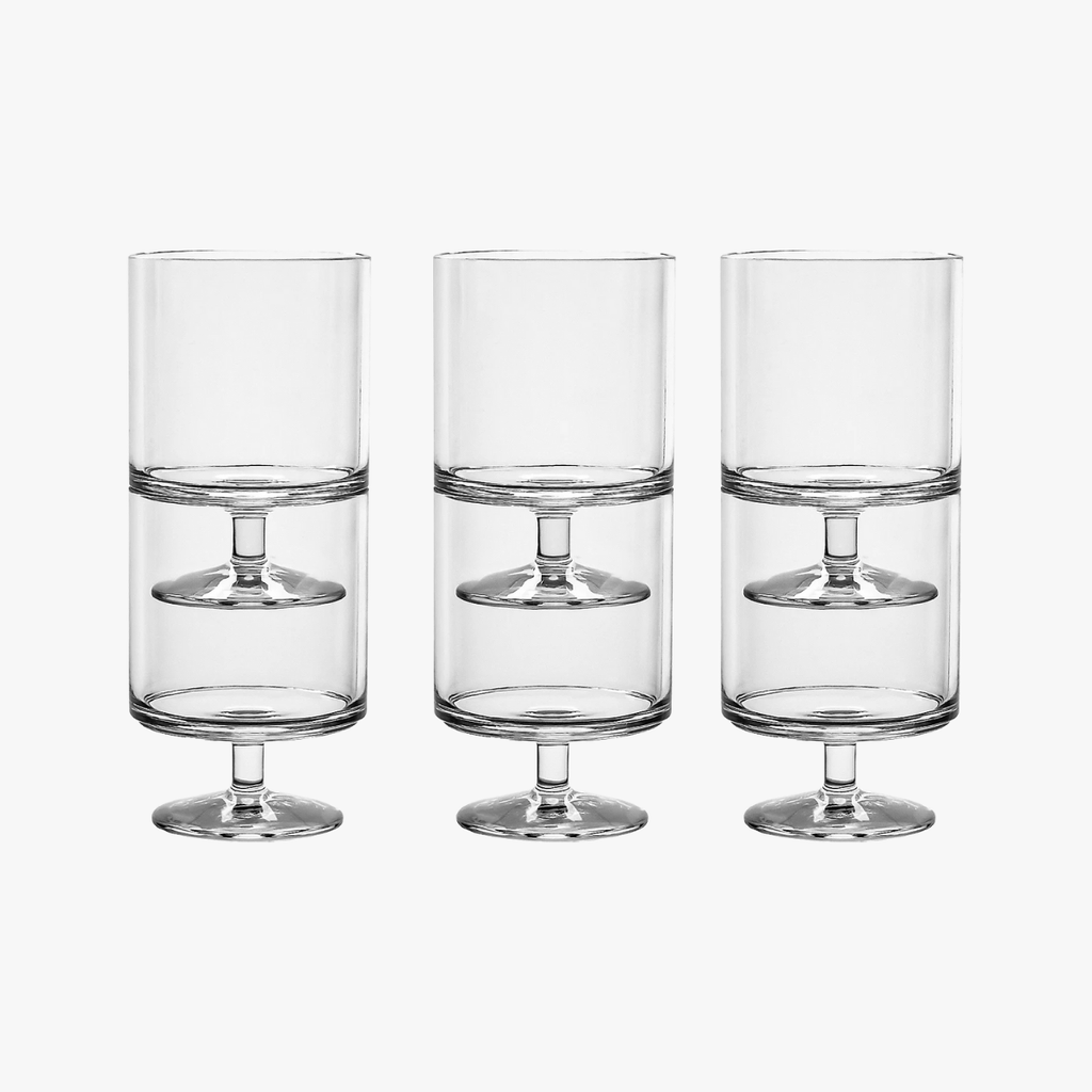 Three clear glass highball glasses on a white background
