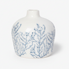White vase with blue branch-like patterns on a white background