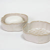 Two ceramic soap dishes on a white background