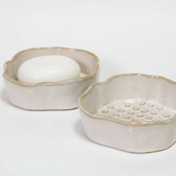 Two ceramic soap dishes on a white background