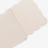 Cream table runner with scalloped edges on a white background
