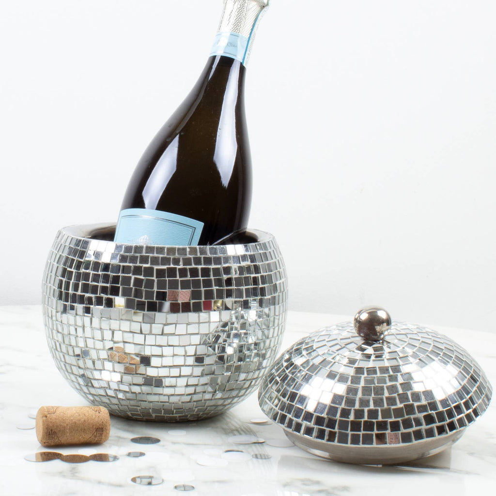 Silver disco ball ice bucket with a bottle of red wine on a white background