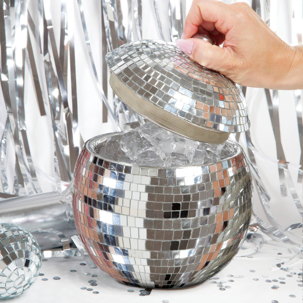 Silver disco ball ice bucket with a hand lifting the lid against a silver tinsel background.