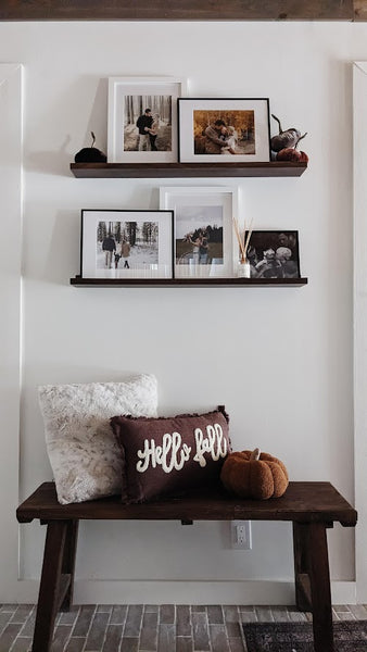 Entryway with fall pillow and pumpkin throw pillow