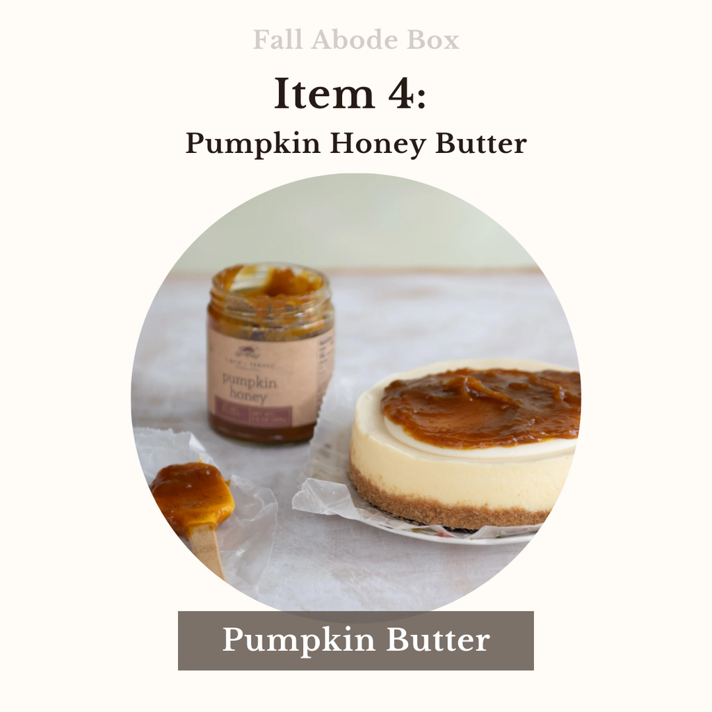 Jar of pumpkin honey butter next to a cheesecake on a white surface with 'Fall Abode Box' text.