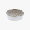 White ceramic soap dish with textured surface on a white background