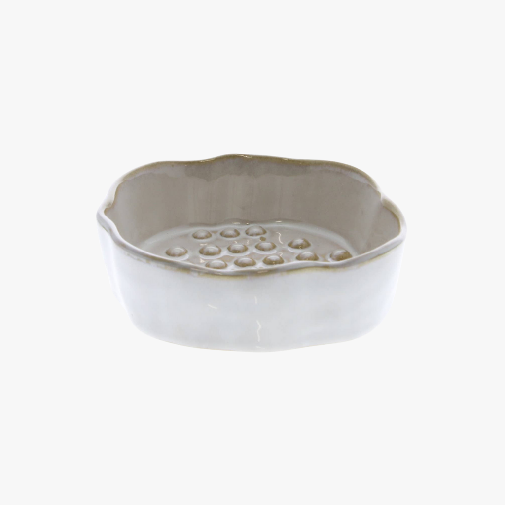 White ceramic soap dish with textured surface on a white background