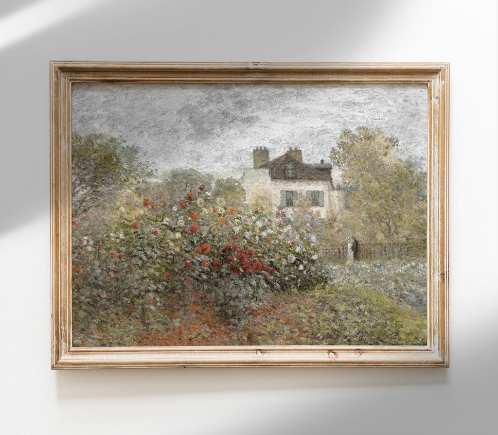 Framed painting of a garden scene with a house and trees on a white wall.
