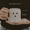 Person holding a white ghost halloween mug with black dots, labeled as 'figurine mugs' with product details.