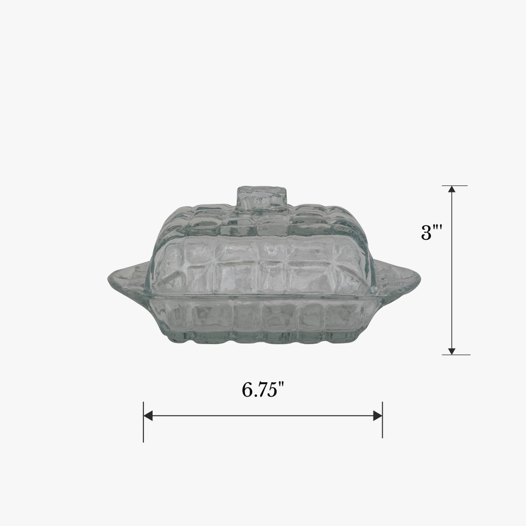 Glass butter dish with measurements on a white background
