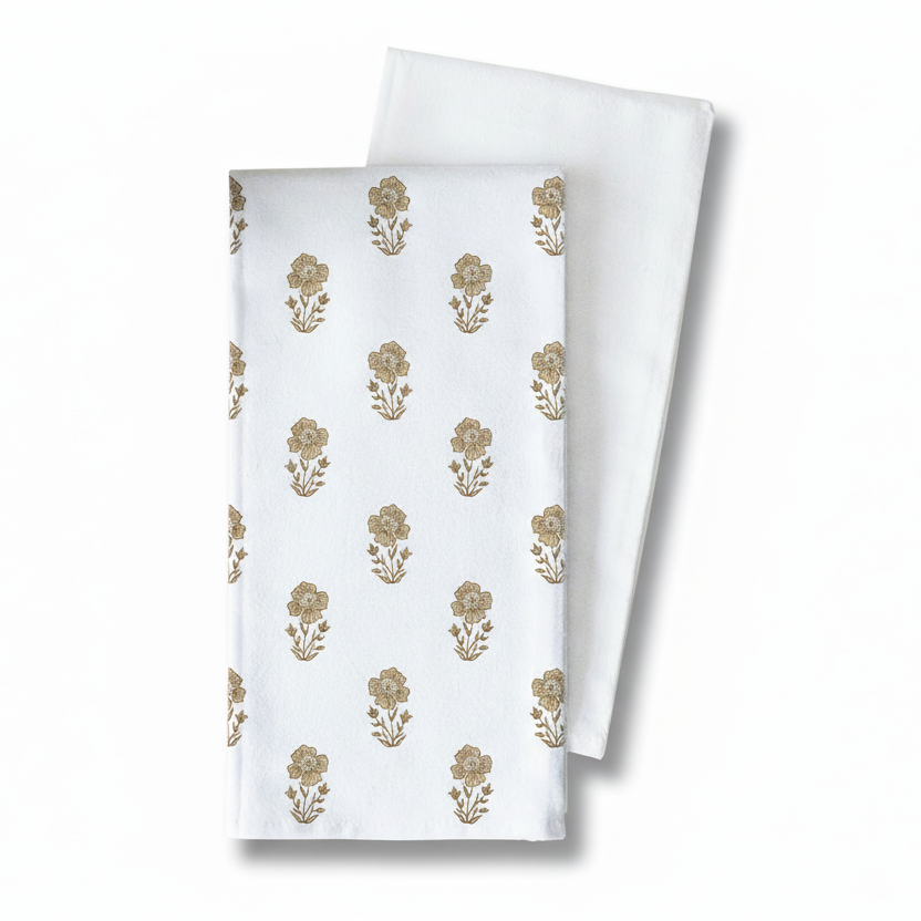 Two white kitchen hand towels with gold floral patterns on a white background