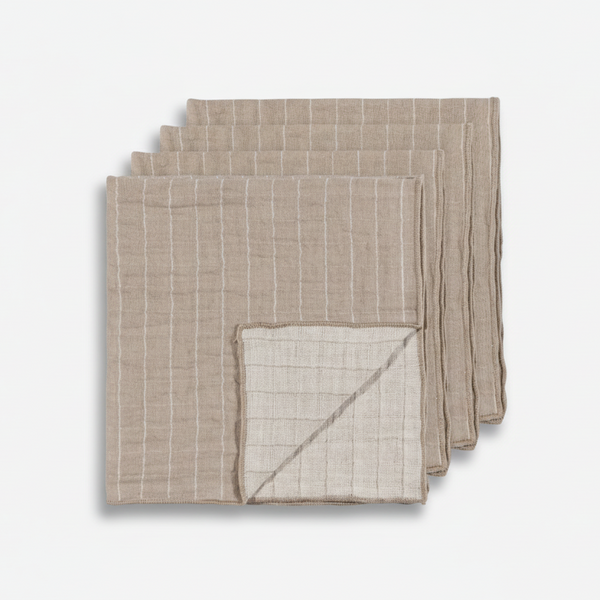 Set of four grey and white stripe napkins on a white background