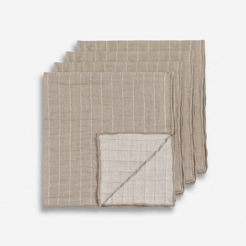 Set of four grey and white stripe napkins on a white background