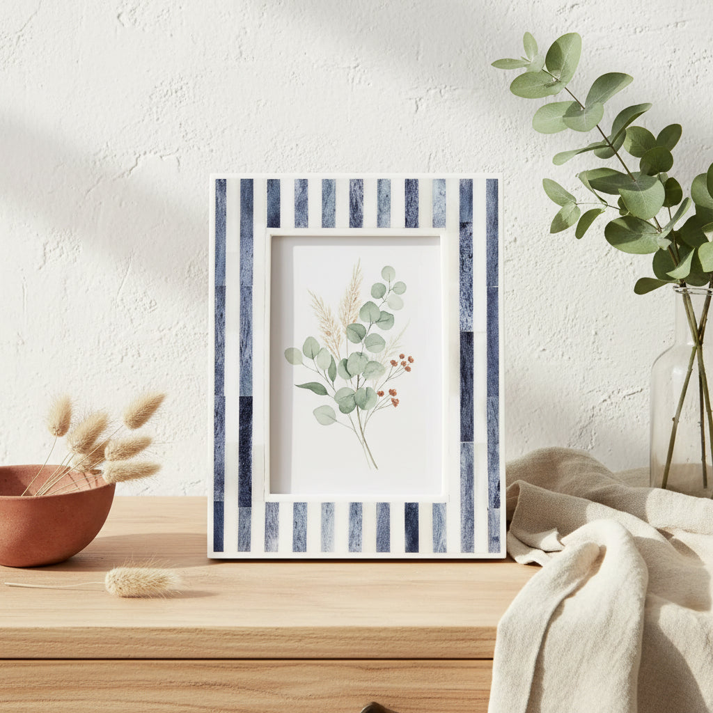 Framed artwork with striped border on a light surface with decorative elements.