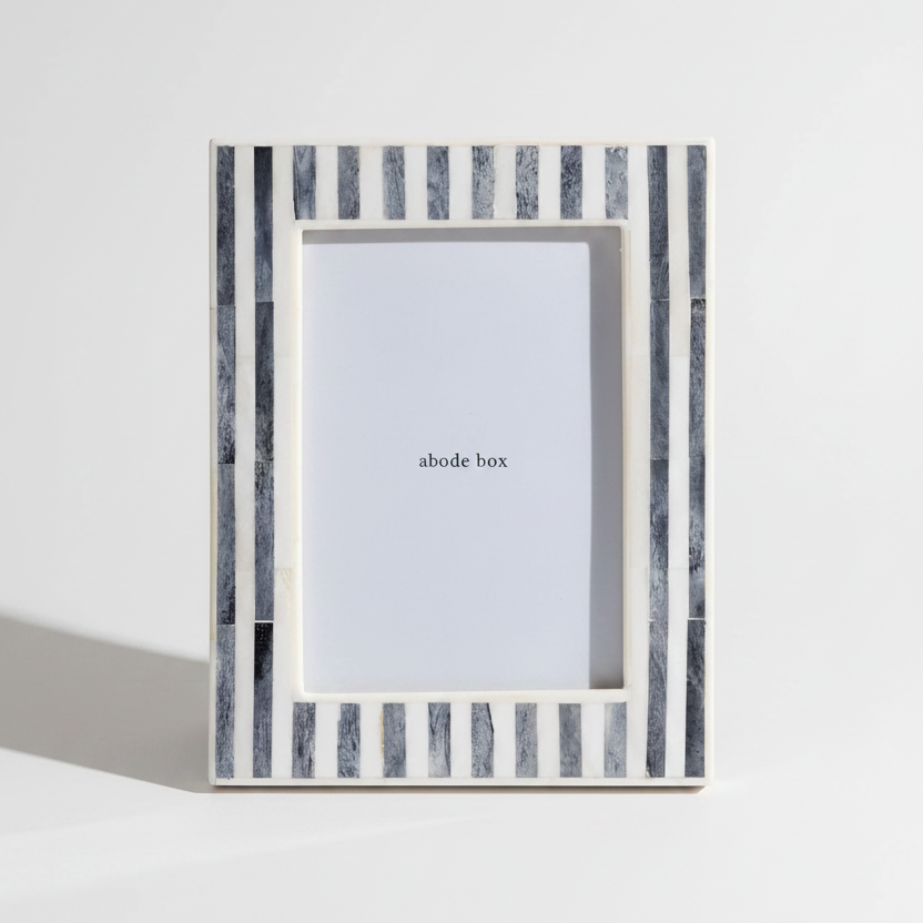 grey and white Striped photo frame with 'abode box' branding on a white background