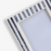 Decorative photo frame with striped grey border on a white background