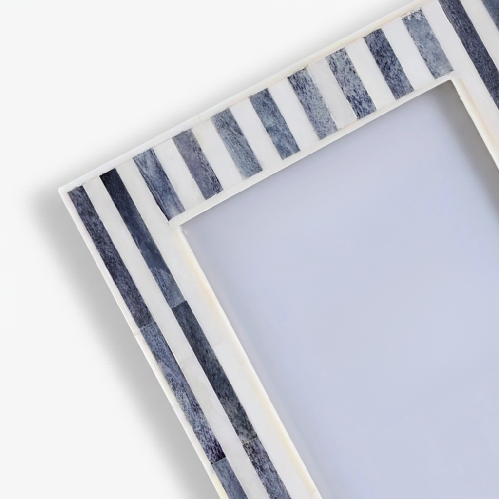 Decorative photo frame with striped grey border on a white background