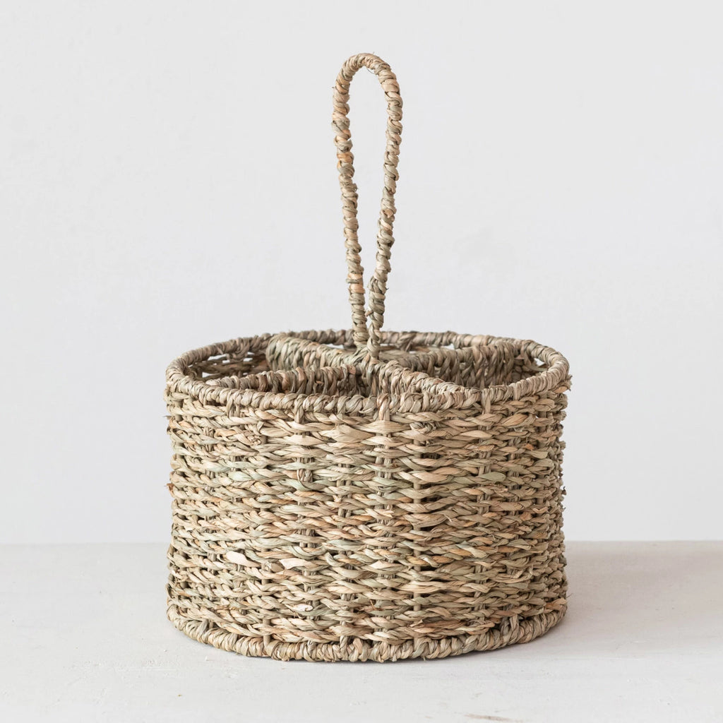 Woven utensil caddy with a handle on a white background
