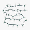 String of clear light bulbs on green wire with a white plug, on a white background