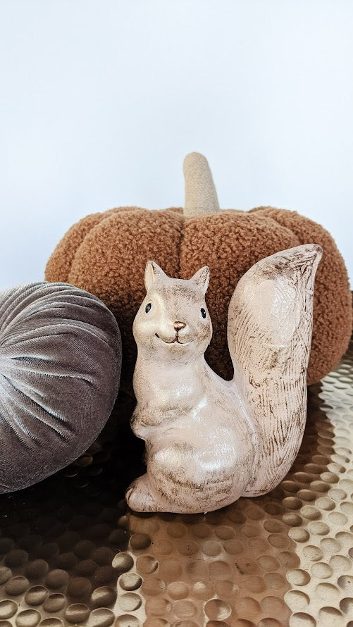 squirrel figurine with pumpkins for fall decorating