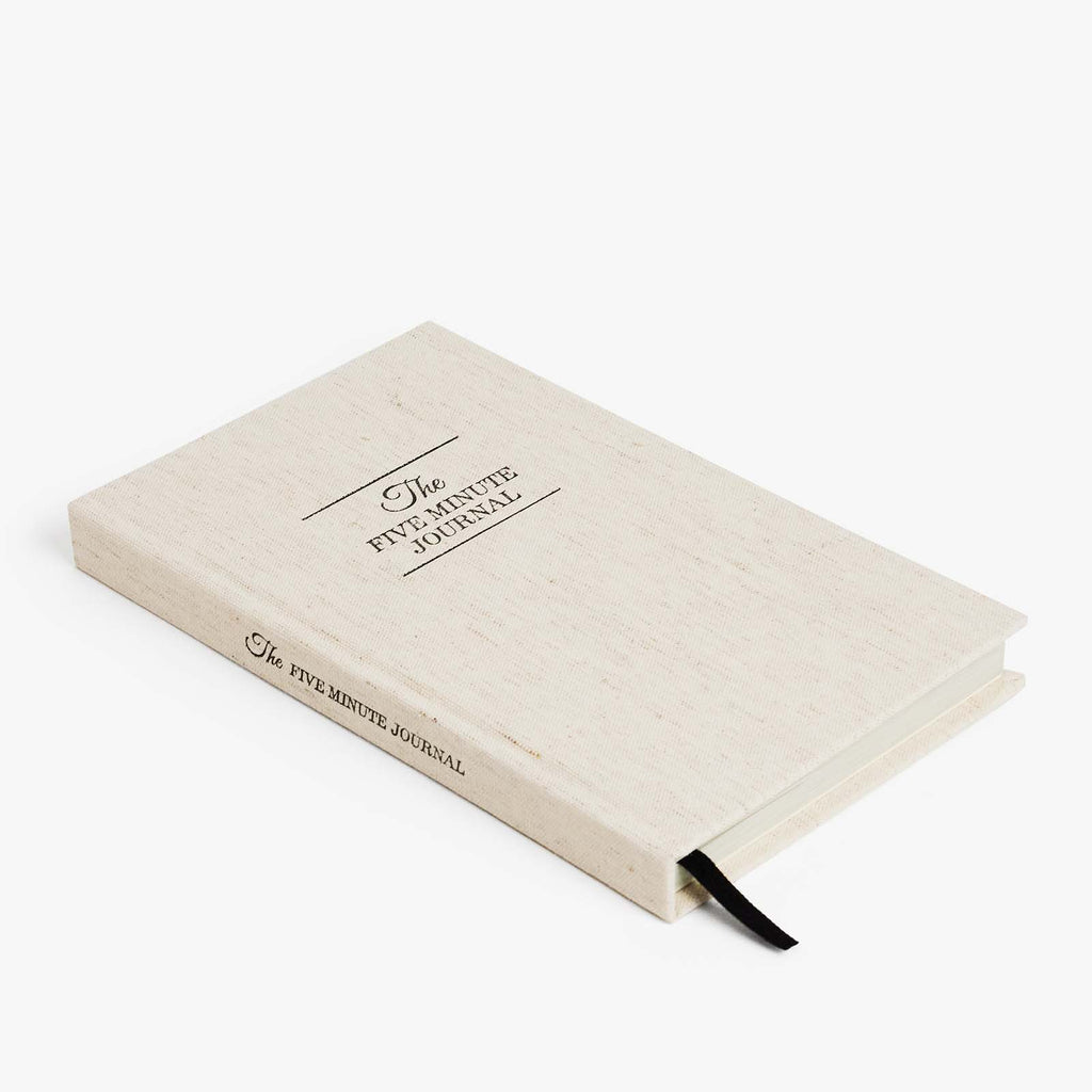 Beige journal with text on a white background