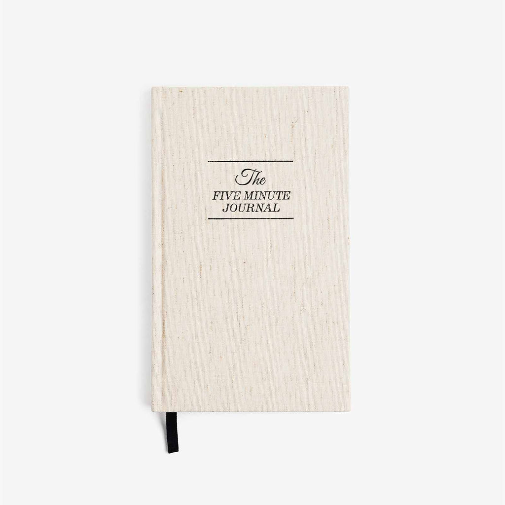 Beige journal with 'The Five Minute Journal' text on a white background