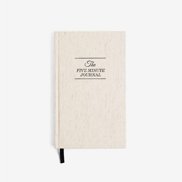 Beige journal with 'The Five Minute Journal' text on a white background