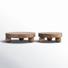 Two wooden round trays with round tops and leg bases on a white background