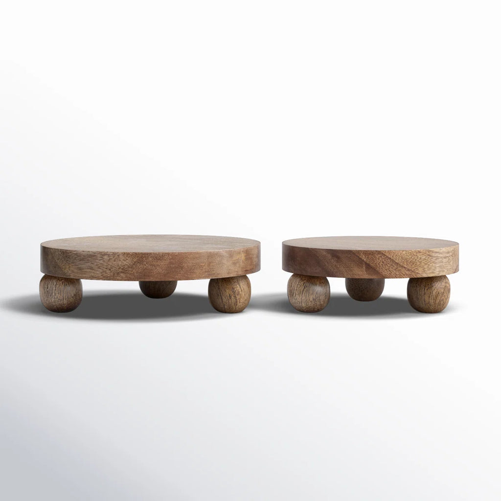 Two wooden round trays with round tops and leg bases on a white background
